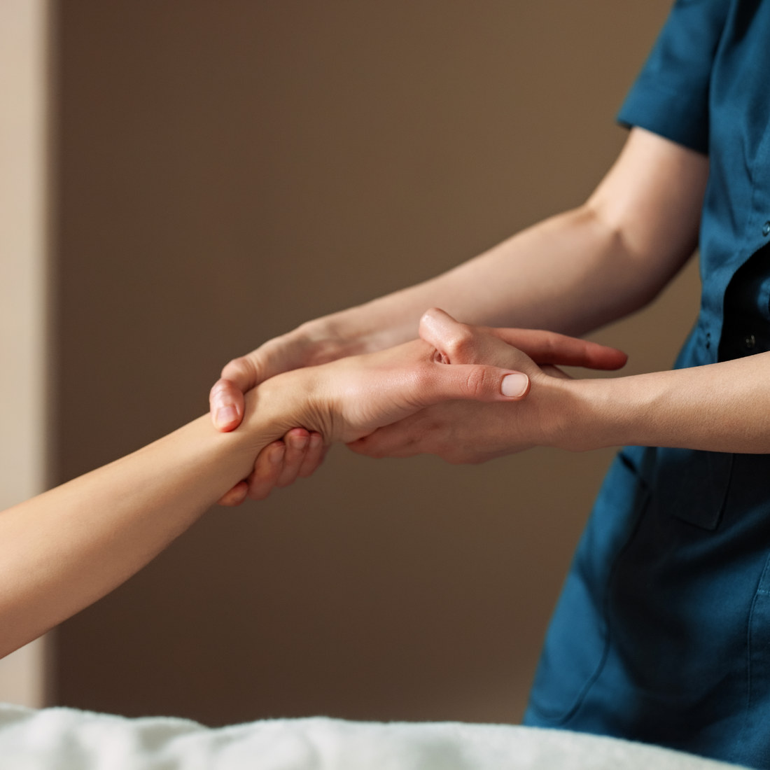 A clinician examining a patient’s arm