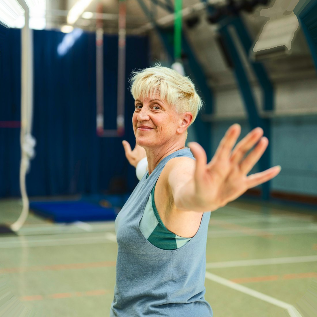 A patient celebrating on a tennis court