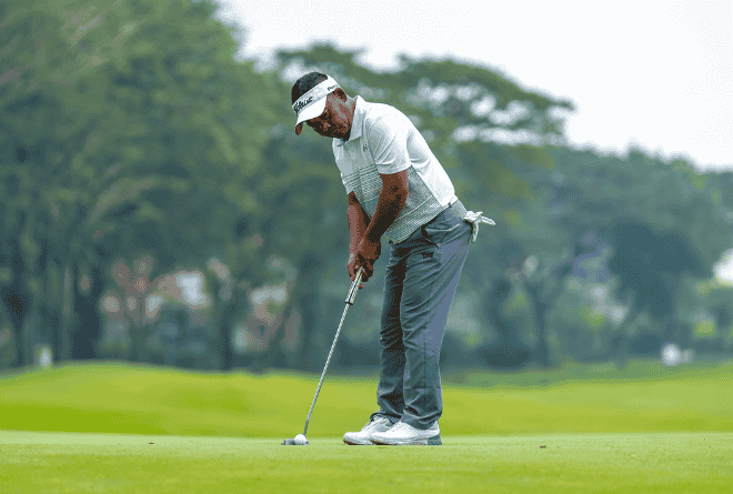 man putting a golf ball