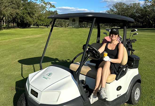 Bailey Propps secondary profile photo of herself on a golf cart in personal section