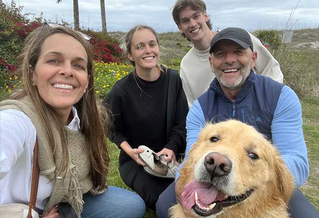 Karen outdoors with her family and dog