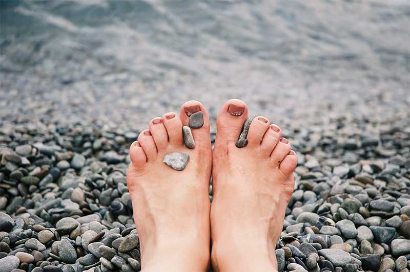 feet and pebbles