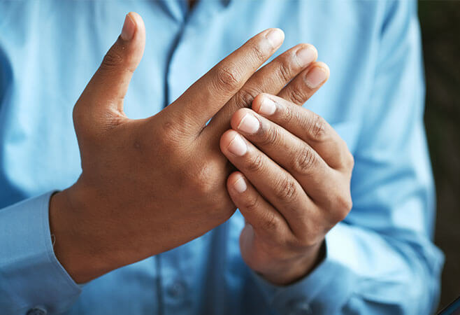 Man holding and suffering from broken finger close up