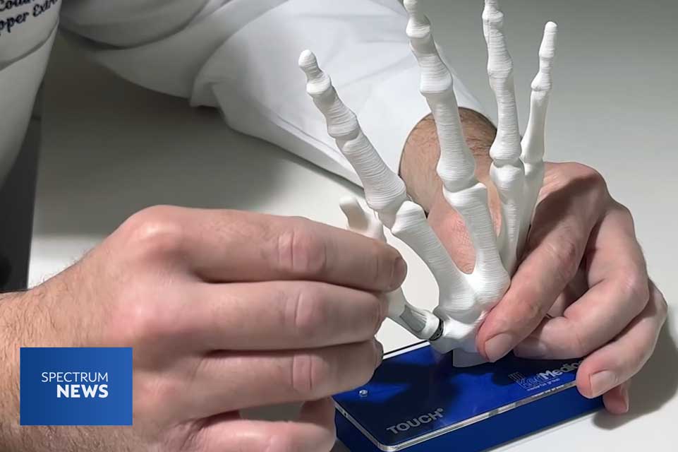 Dr Collins show the new Touch CMC thumb implant