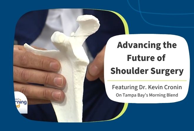 Dr Cronin holding a custom shoulder guide.
