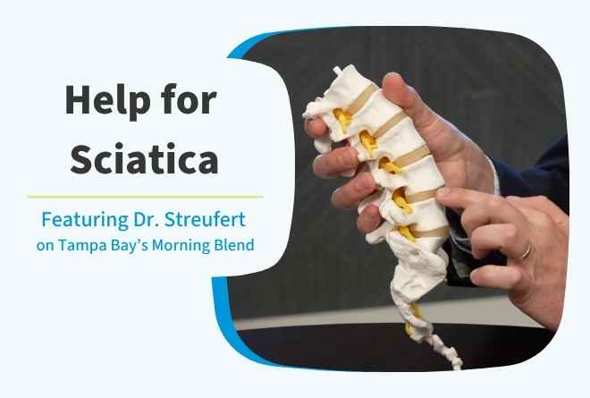 Dr. Ben Streufert holding a prop of a spine