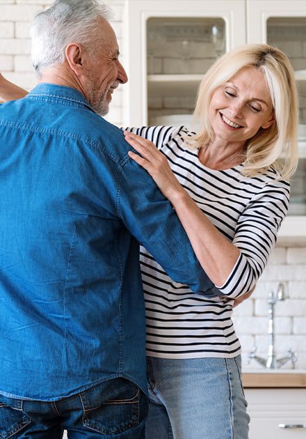 Happy senior couple dancing in kitchen