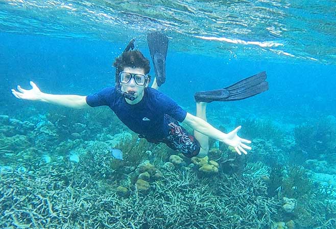 Dr. Brett Cann snorkling on a reef
