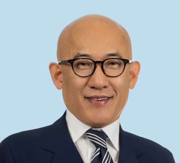 Dr. Hogan Yi professional headshot wearing dark blue suit and tie.