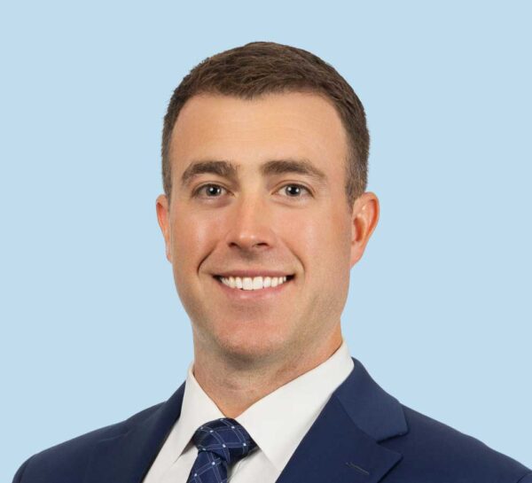 Dr. Michael Elsenbeck professional headshot wearing a blue suit and tie.