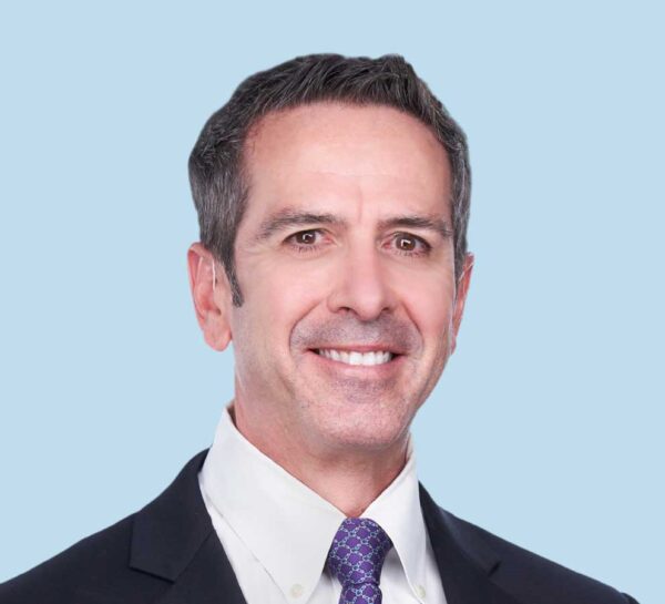 Peter V. Lopez, MD professional headshot wearing black suit and purple tie