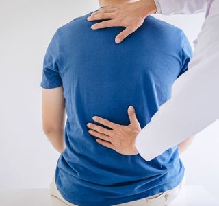 physician and patient back pain exam