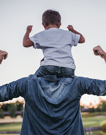 Father with young son on shoulders