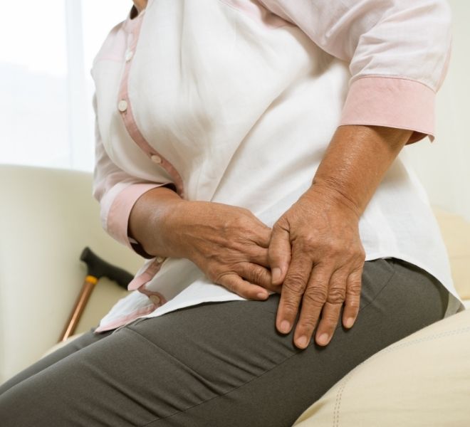 Woman sitting with hip pain